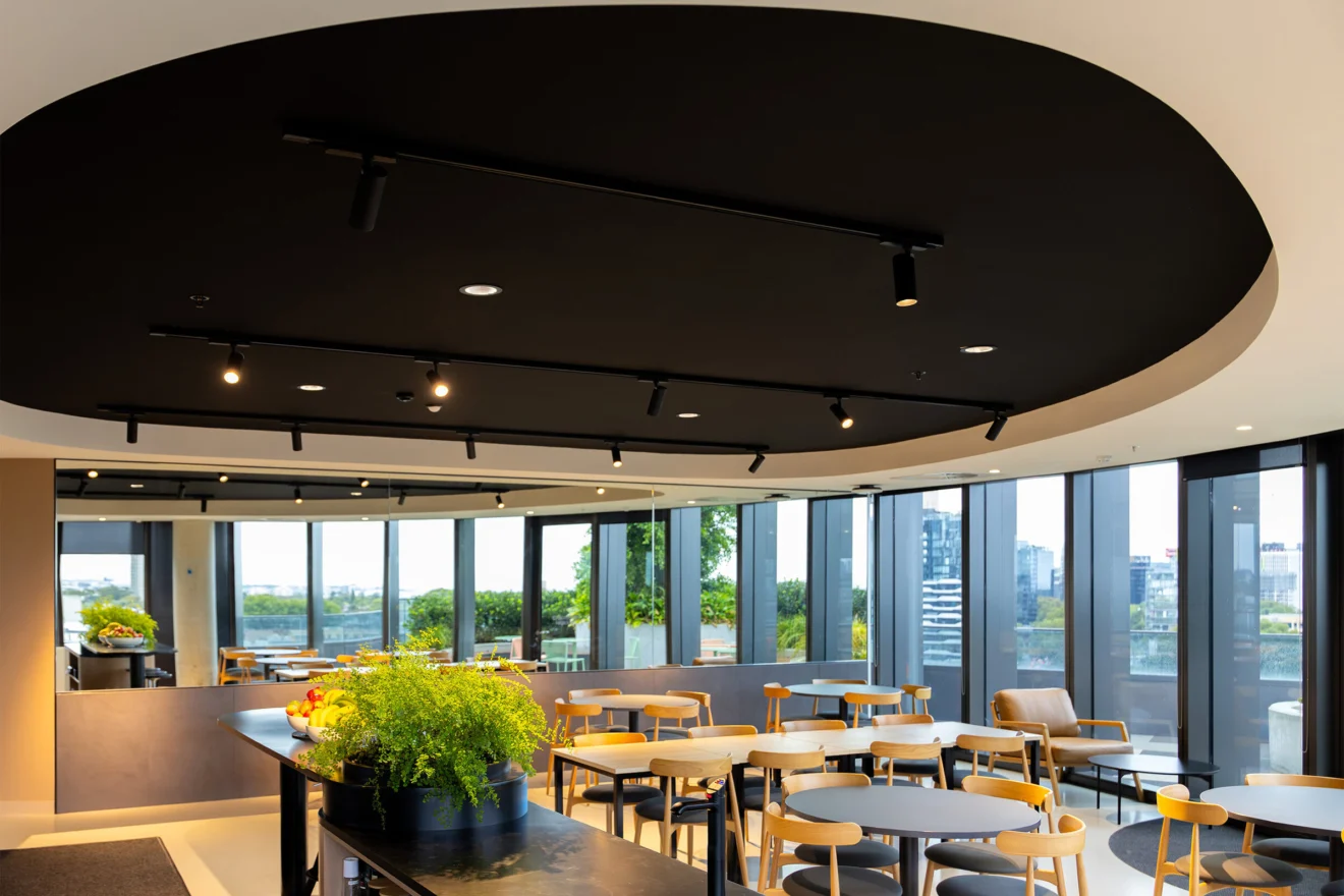 Staff breakout area with a circular lit ceiling at the Acciona head office