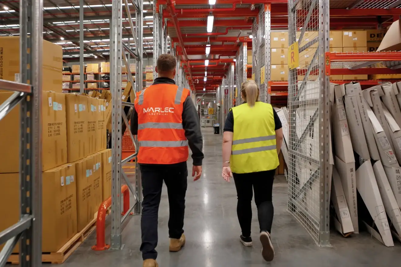 Marlec electricians walking an aisle of the Auto Parts Group warehouse in Dandenong
