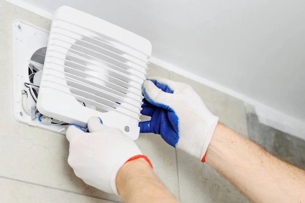 Wall exhaust fan being fitted
