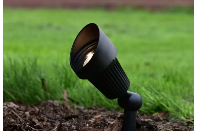 Black LED garden spotlight in a garden bed