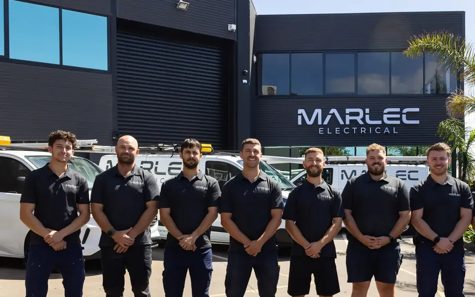 The Marlec Electrical team in their dark-grey uniforms outside the Marlec workshop
