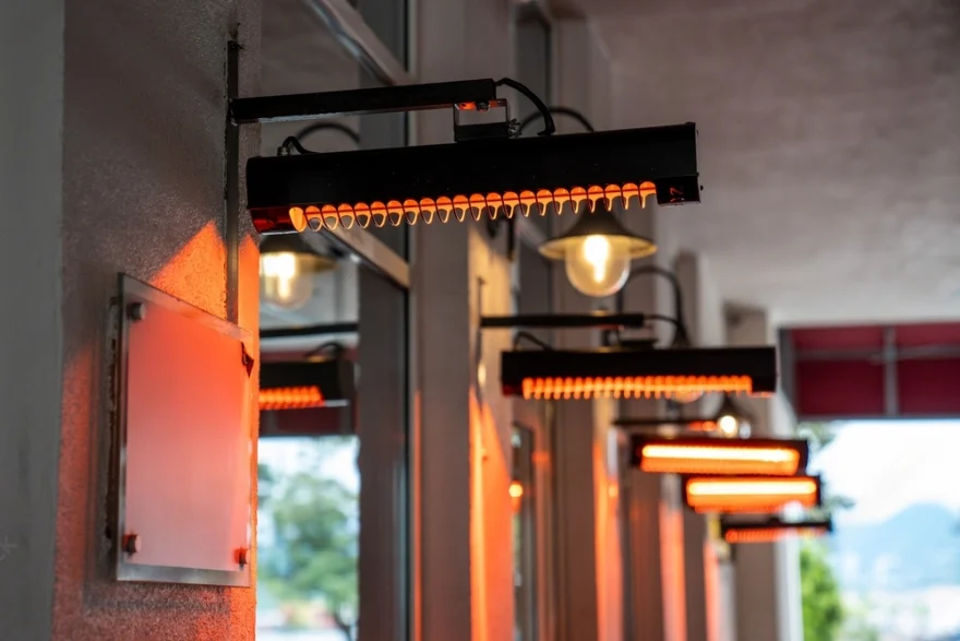 Wall-mounted electric strip heaters on a covered patio