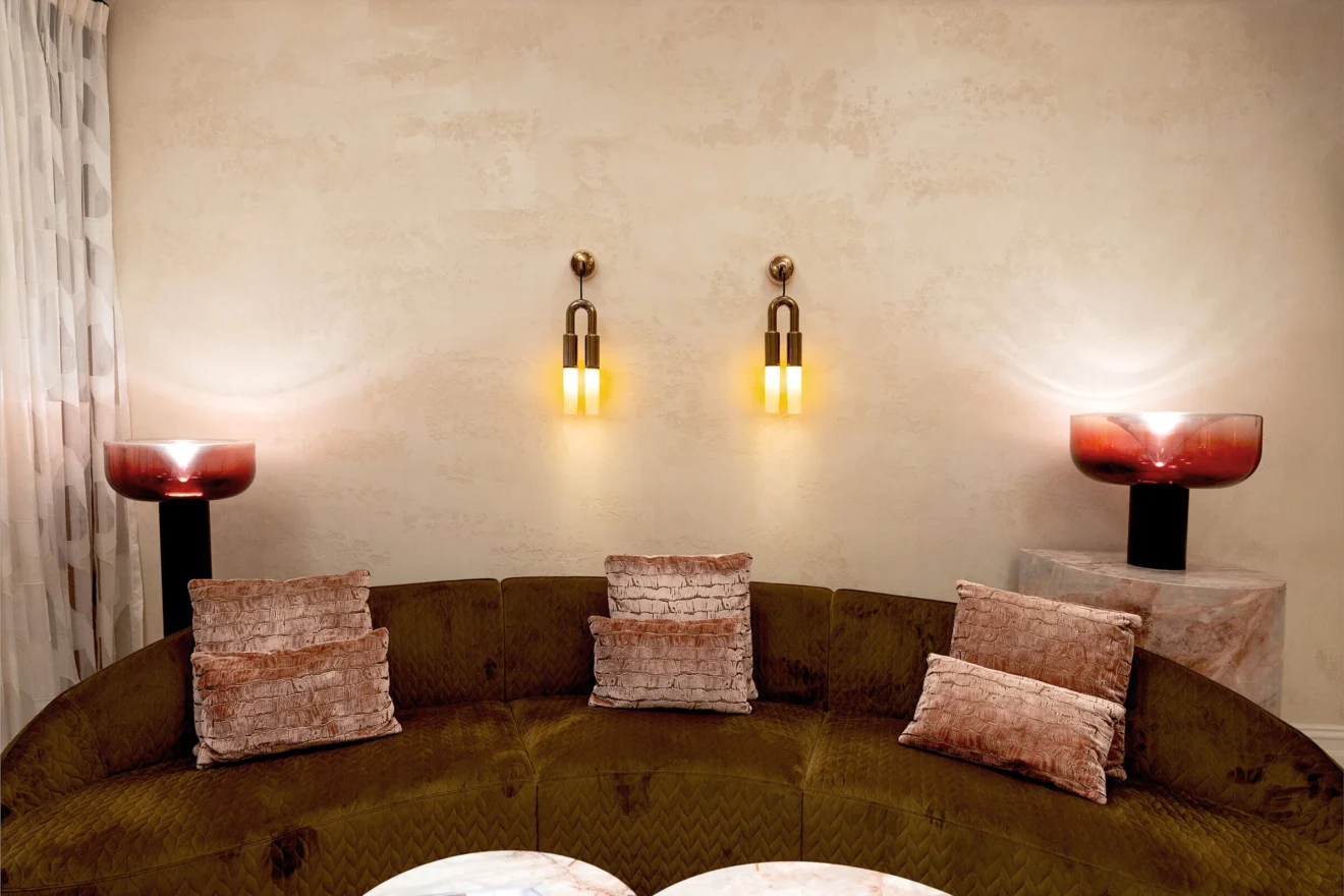 Banquette seating with paired wall lights at The Sebel Melbourne