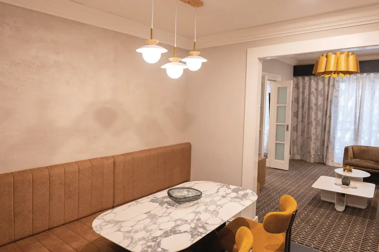Dining nook with pendant lights in a suite at The Sebel Melbourne