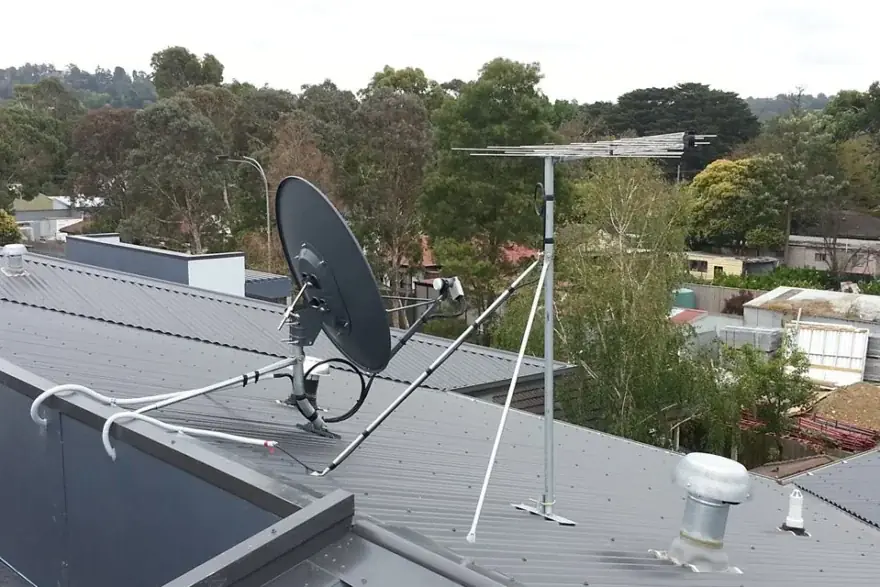 TV antenna and satellite dish on a house roof